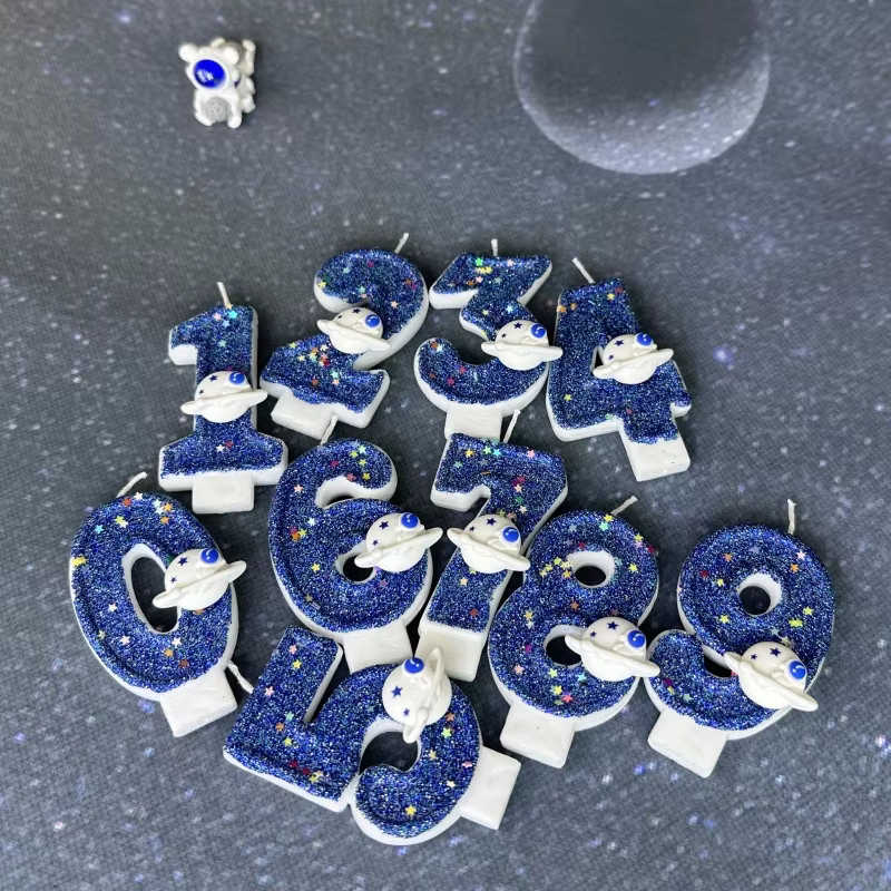 Celebrate in cosmic style with these blue number-shaped birthday candles featuring planets and stars! Each candle adds intergalactic fun to any cake with its vibrant space-themed design. Made from high-quality, non-toxic wax, they burn evenly and are perfect for both kids' and adults' parties. Available in numbers 0-9, these candles will make your celebration truly out of this world.